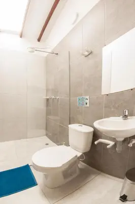 a bathroom with a toilet and a sink at Vivienda turística mi sueño Jardín in Jardin