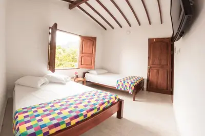 a bedroom with two beds and a window at Vivienda turística mi sueño Jardín in Jardin