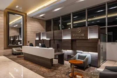 a lobby of a hotel with a desk and chairs at Estelar La Torre Suites in Medellín