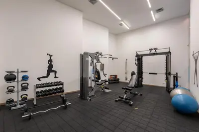a gym with treadmills and machines in a room at Estelar La Torre Suites in Medellín