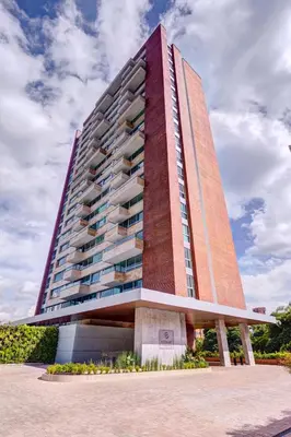 a tall building with a red brick at Estelar La Torre Suites in Medellín