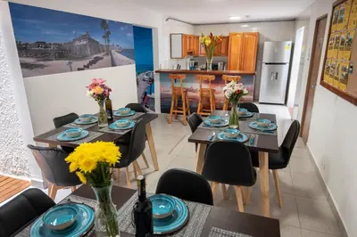 a kitchen and dining room with a table and chairs at Air Guest House - con Desayuno & Jacuzzi Social in Medellín
