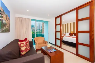 a living room with a couch and a bed at The Morgana Poblado Suites Hotel in Medellín