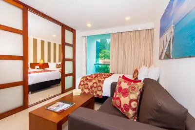 a hotel room with a bed and a couch at The Morgana Poblado Suites Hotel in Medellín