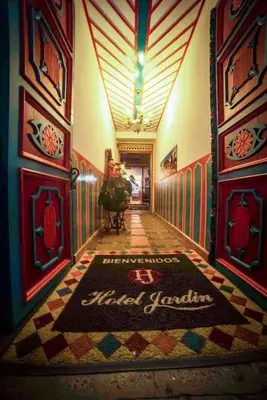 a hallway with a tile floor and a sign on the floor at Jardín by Bernalo Hotels in Jardin