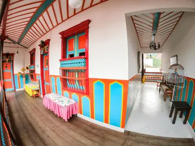 a room with brightly colored walls and wooden floors at Jardín by Bernalo Hotels in Jardin