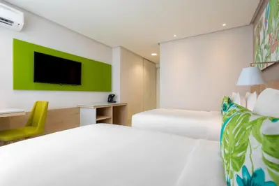 a hotel room with a bed and a tv at Mia Hotel Choco in Quibdó