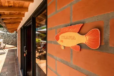 a fish sign on the side of a building at Serendipity Hospedaje Boutique in Guatapé