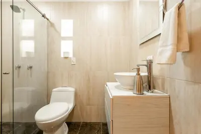a bathroom with a toilet and a sink and a shower at Serendipity Hospedaje Boutique in Guatapé