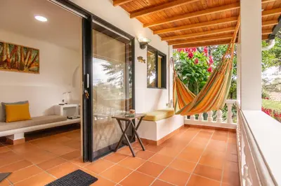 a room with a balcony with a hammock at Serendipity Hospedaje Boutique in Guatapé