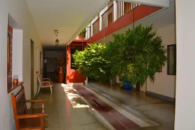 a hallway with potted plants in a building at Hotel Tayrona in Puerto Berrío