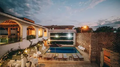 a house with a swimming pool and a brick building at Ángel de Santa Fe by Bernalo Hotels in Santa Fe de Antioquia