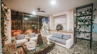 a living room with two couches and a christmas tree at Ángel de Santa Fe by Bernalo Hotels in Santa Fe de Antioquia