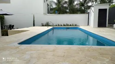 a swimming pool with blue water in a backyard at Villas del Guali - Piscina Privada in Santa Fe de Antioquia