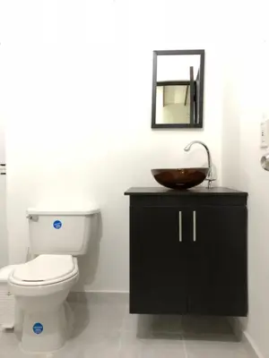 a bathroom with a toilet and a sink at Villas del Guali - Piscina Privada in Santa Fe de Antioquia