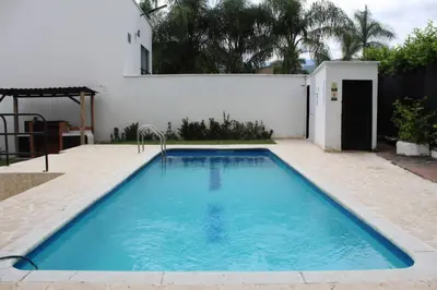 a swimming pool in the backyard of a house at Villas del Guali - Piscina Privada in Santa Fe de Antioquia