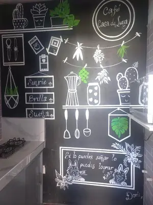 a wall with chalk drawings of different items on it at Casa de Luna in La Dorada