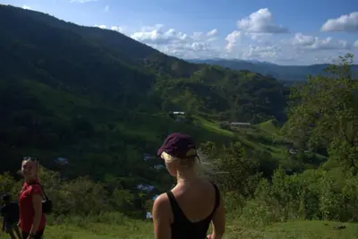 a woman standing on a hill looking at a valley at Ritmo del Rio in San Rafael