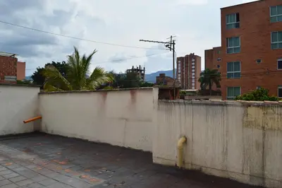 a concrete wall with a fire hydrant in a city at Buntes House-Casa Hotel Laureles-Estadio in Medellín