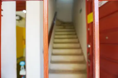 a stairway in a room with wooden stairs at Buntes House-Casa Hotel Laureles-Estadio in Medellín
