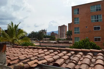 an old tile roof in front of a brick building at Buntes House-Casa Hotel Laureles-Estadio in Medellín