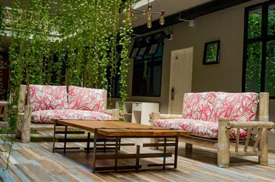 a patio with two couches and a coffee table at Hotel El Meson in La Dorada