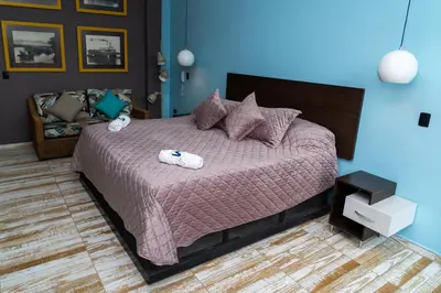 a bedroom with a bed with two towels on it at Hotel El Meson in La Dorada