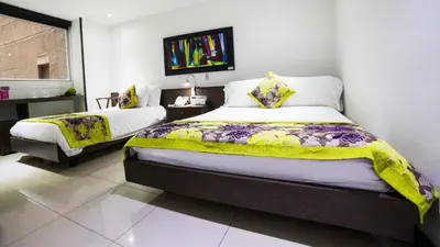 a bedroom with two beds in a room at Hotel Golden Palermo in Medellín