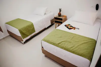a bedroom with two beds and a night stand at Hotel Sie7e in Medellín
