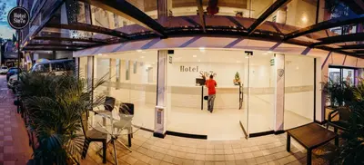 a person standing in a window of a store at Hotel Sie7e in Medellín