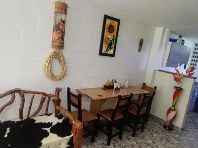 a dining room with a wooden table and chairs at Apartamento Campestre Medellin in Medellín