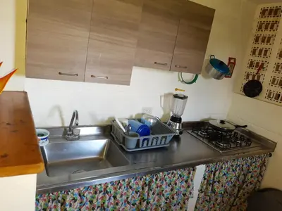 a kitchen sink with a dish drying rack next to it at Apartamento Campestre Medellin in Medellín