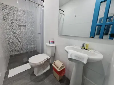 a white bathroom with a toilet and a sink at CABAÑA 1 LA ALDEA in Doradal