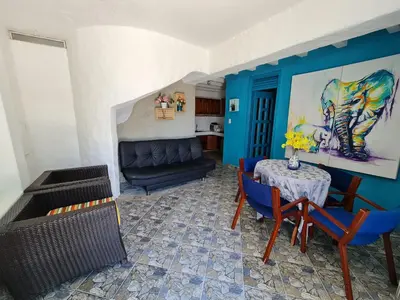 a living room with a table and chairs and a couch at CABAÑA 1 LA ALDEA in Doradal