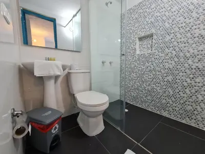 a bathroom with a toilet and a glass shower at CABAÑA 1 LA ALDEA in Doradal