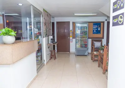 a grocery store aisle with a counter and a pharmacy at Hotel Conquistadores in Medellín