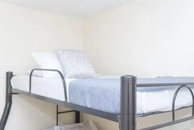 a bunk bed in a room with white walls at Hotel Conquistadores in Medellín