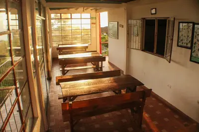 a row of benches sitting in a room at Eco Lodge La Juanita in Manizales