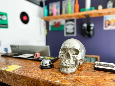 a skull sitting on a desk next to a computer at Rock Hostel Medellin in Medellín