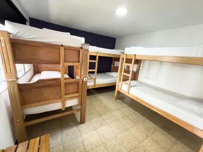 a room with three bunk beds in it at Rock Hostel Medellin in Medellín
