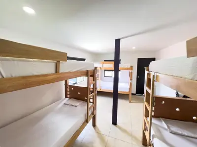 a room with three bunk beds in a hostel at Rock Hostel Medellin in Medellín