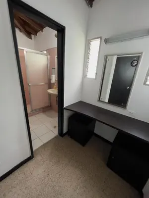 a bathroom with a mirror and a sink and a mirror at Rock Hostel Medellin in Medellín