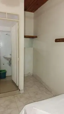 a bathroom with a sink and a door to a room at HOTEL LA QUINTA in La Dorada
