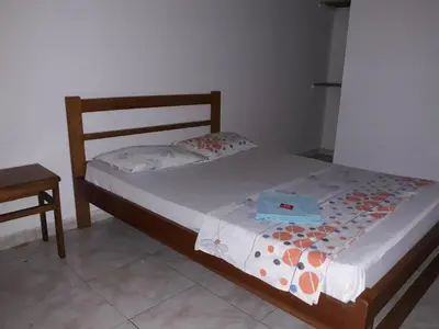 a bedroom with a bed and a nightstand and a bed sidx sidx sidx sidx at HOTEL LA QUINTA in La Dorada