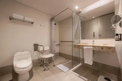 a bathroom with a toilet and a sink and a shower at Hotel Estelar Square in Medellín