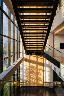 a hallway in a building with glass windows at Hotel Estelar Square in Medellín