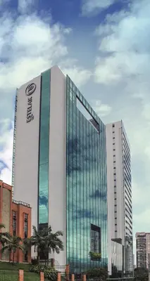 a tall building with a sign on the side of it at Hotel Estelar Square in Medellín