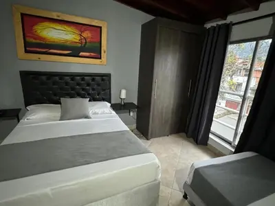 a bedroom with a large bed and a window at Gemas San Joaquin 1 in Medellín