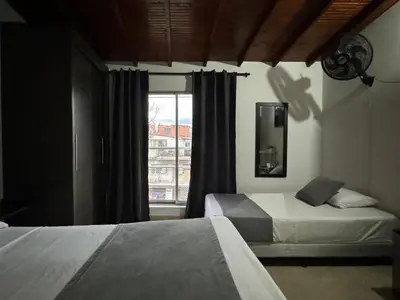 a bedroom with two beds and a window at Gemas San Joaquin 1 in Medellín
