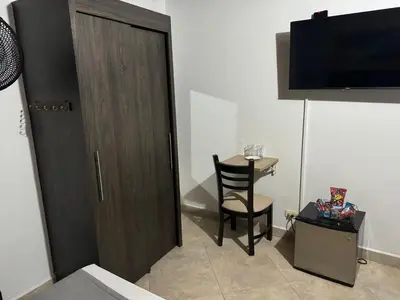 a room with a door and a chair and a table at Gemas San Joaquin 1 in Medellín